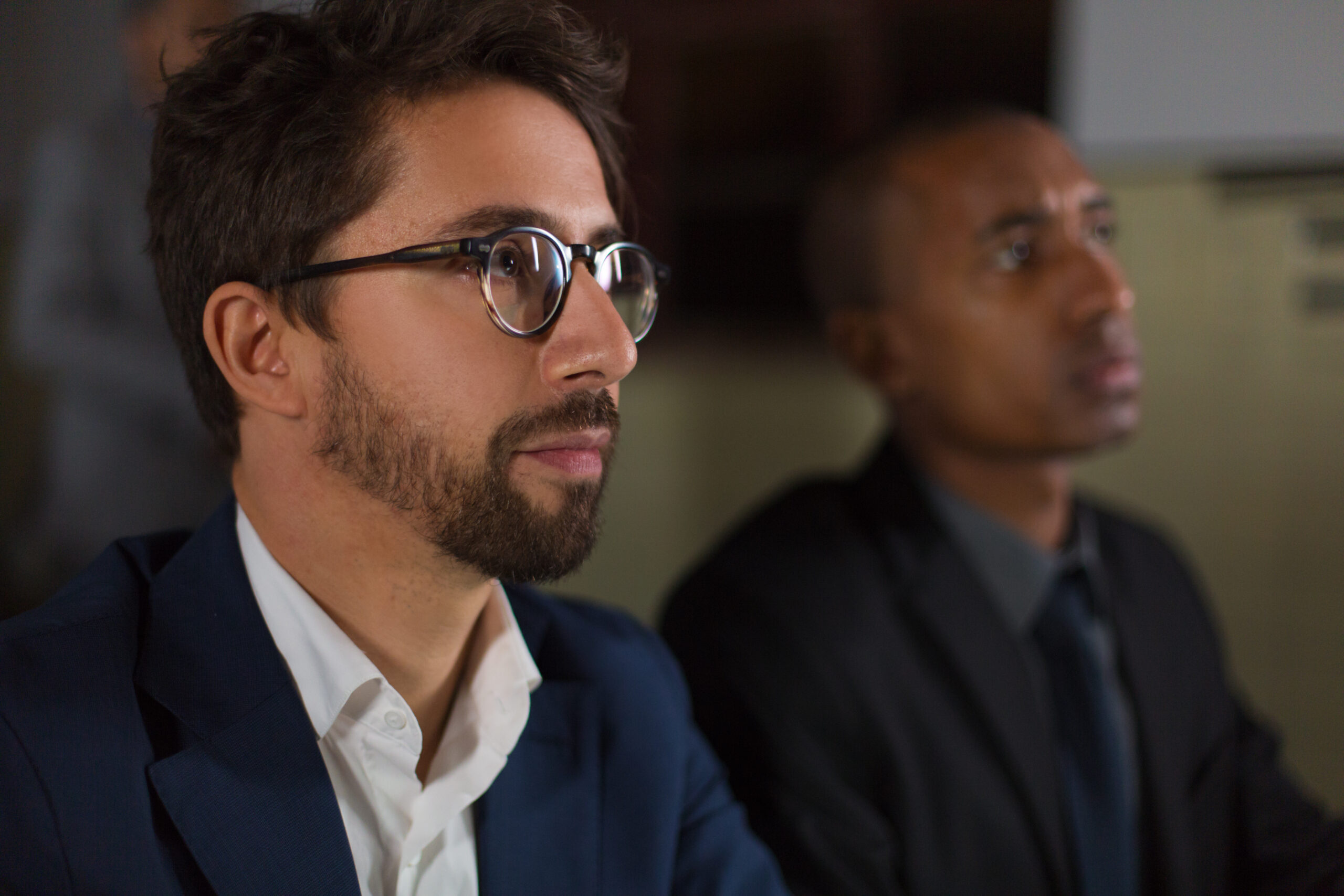 businessman in eyeglasses working in dark office